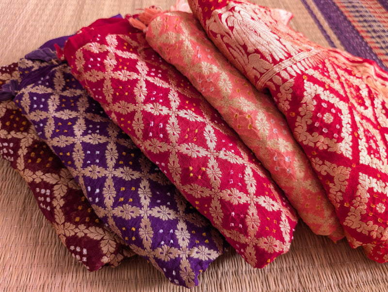 a stack of beautiful bandhani dupattas