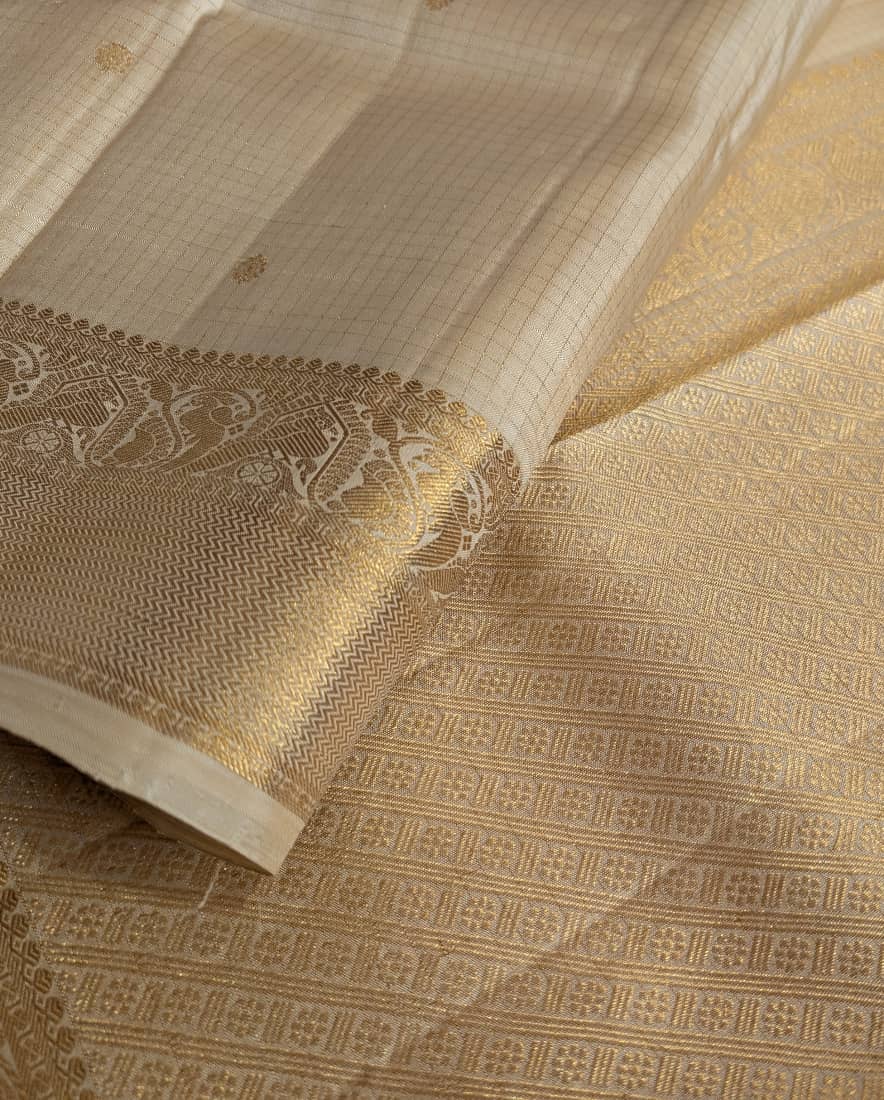 A close-up pic of a cream kanjivaram silk saree