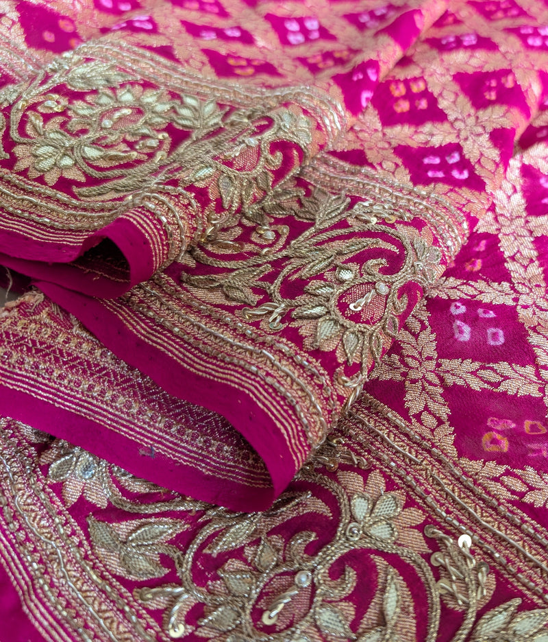 Close-up of a pink bandhani fabric with intricate gota patti embroidery
