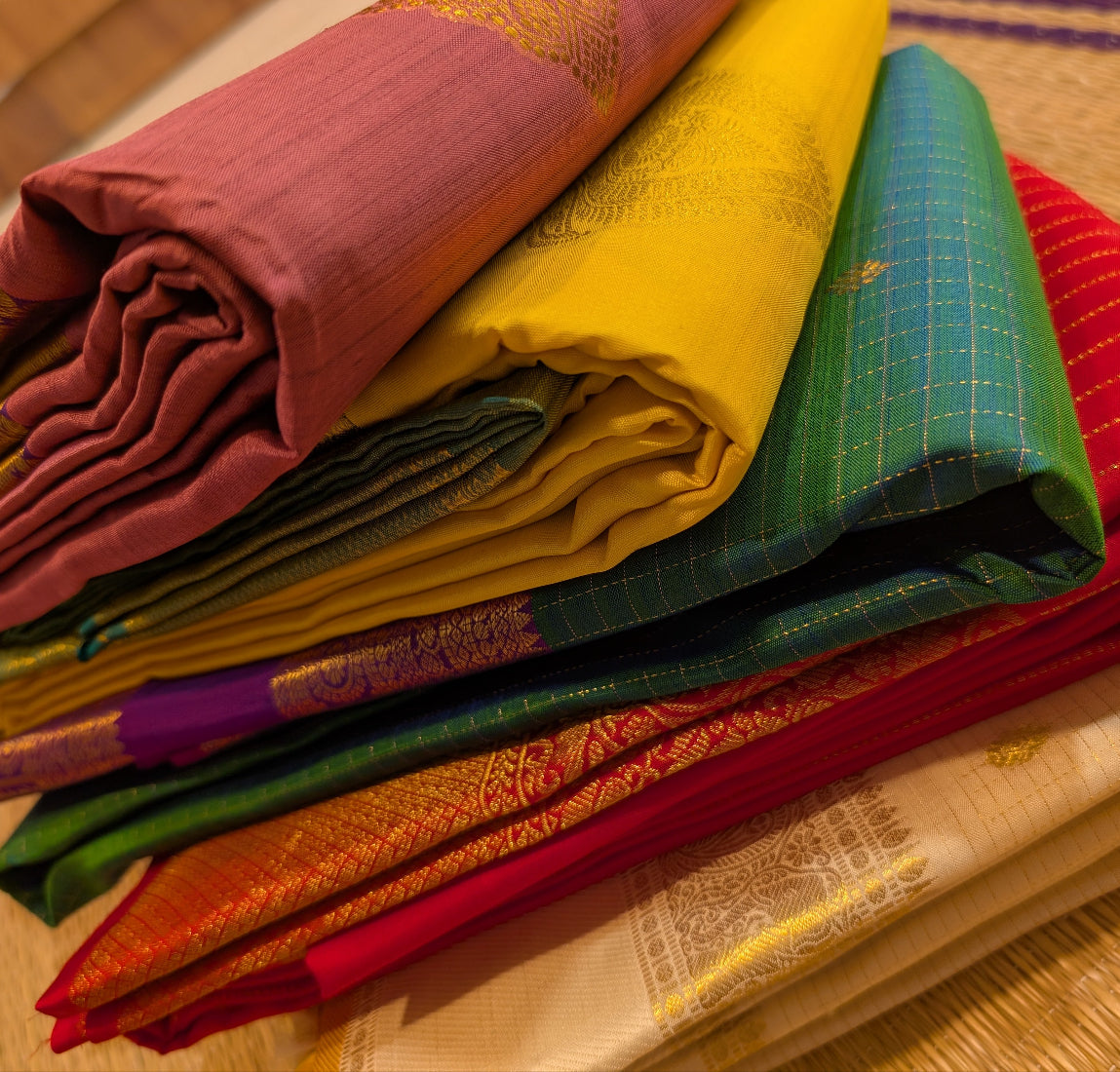 stack of beautifully folded kanjivaram silk sarees