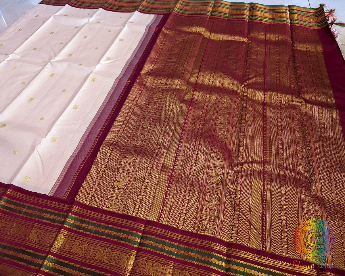 Off white Kanjivaram silk saree pallu view with green and deep red contrast