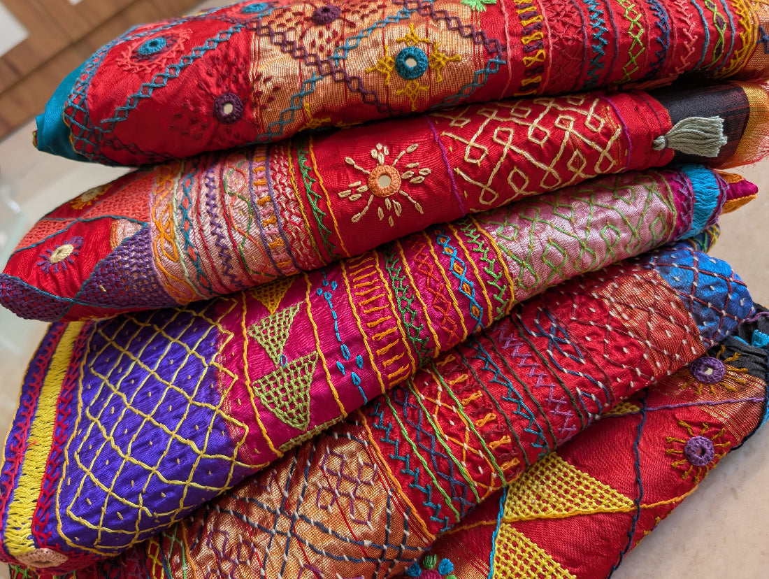 stack of colourful lambani saree